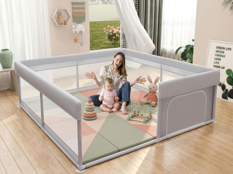 Toddler dragging toy bear across the breathable mesh wall of a Hiaksedt playpen